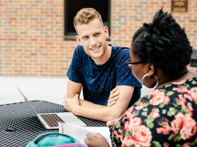 SBU students doing homework outside